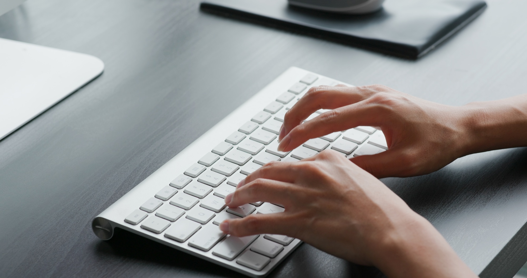 Woman type on keyboard at home